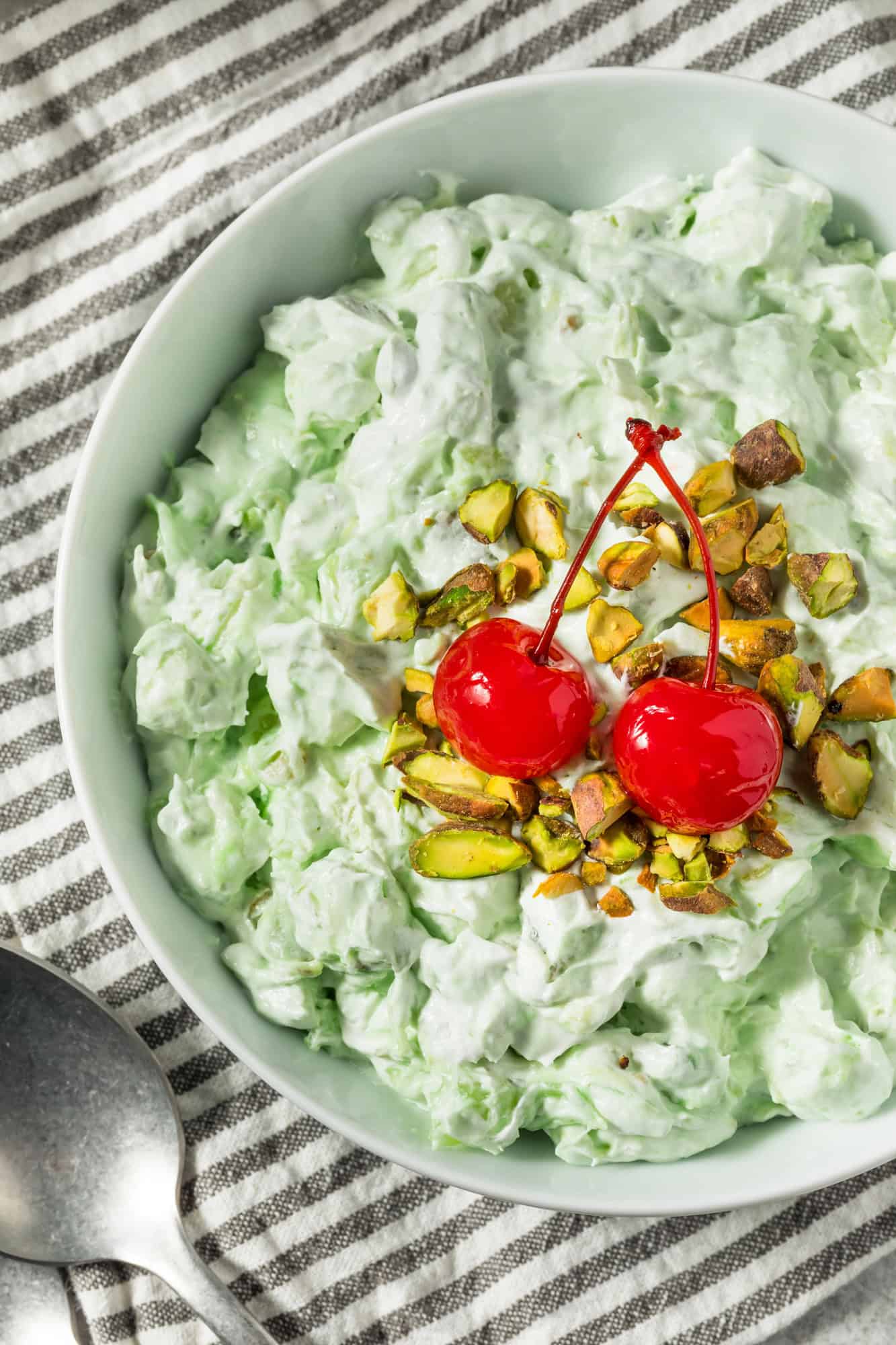 green fluff dessert with cherries and nuts on top