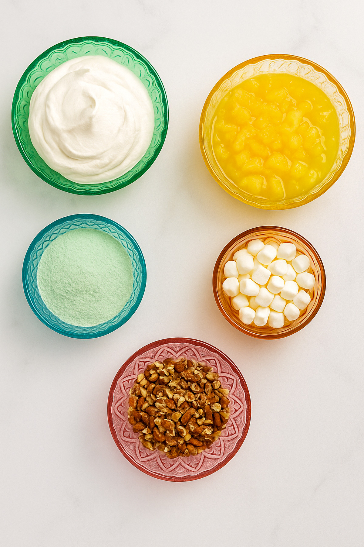 the ingredients for watergate salad in vintage bowls on a white background