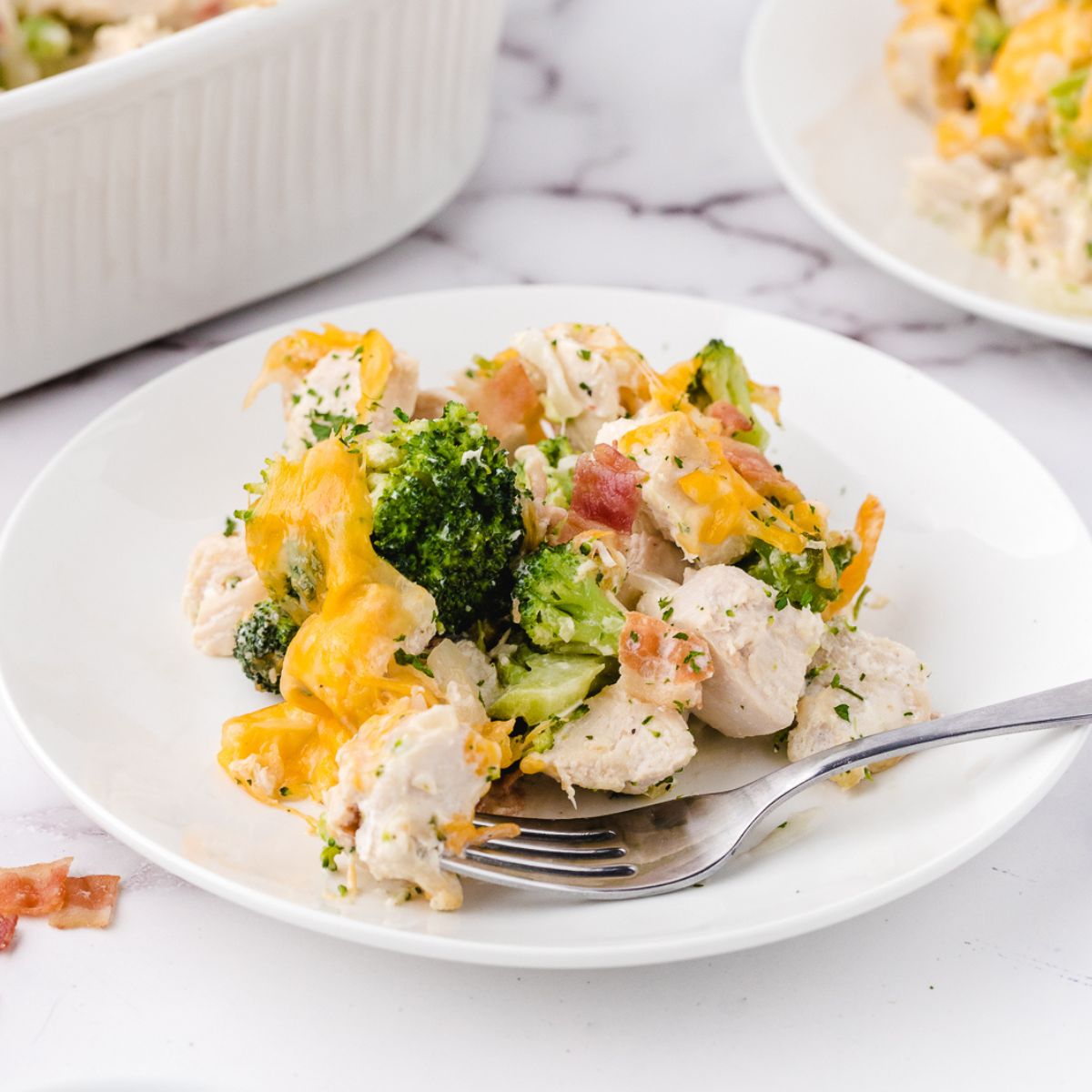 a plate of chicken bacon ranch casserole on a plate with a fork