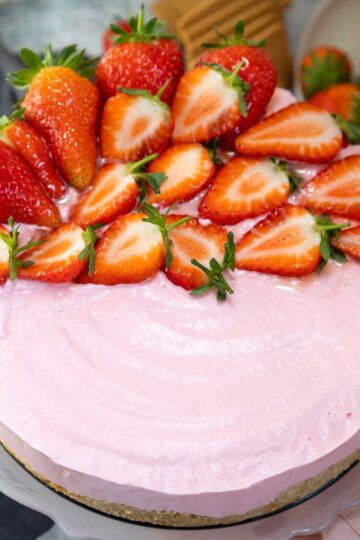 Easy No Bake Strawberry Cheesecake topped with sliced strawberries