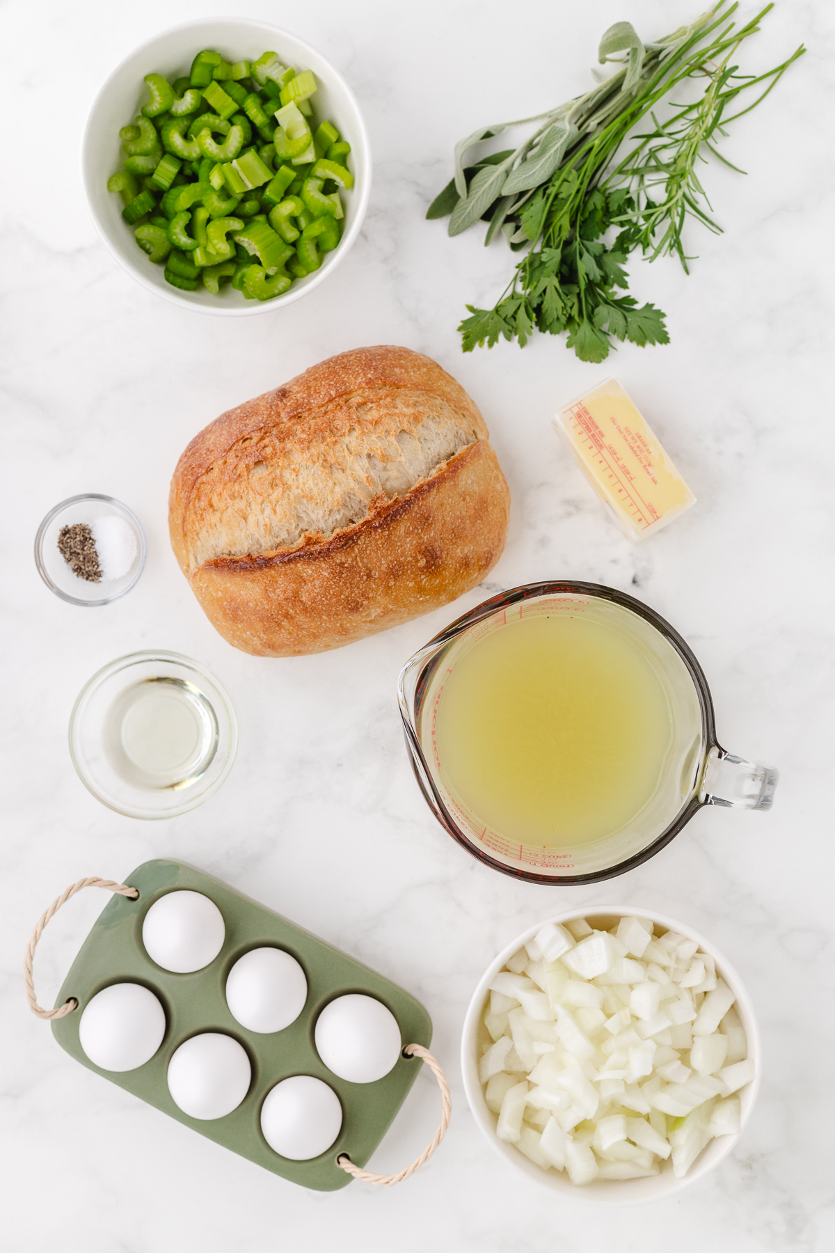 old fashioned stuffing ingredients with bread on a white marble counter