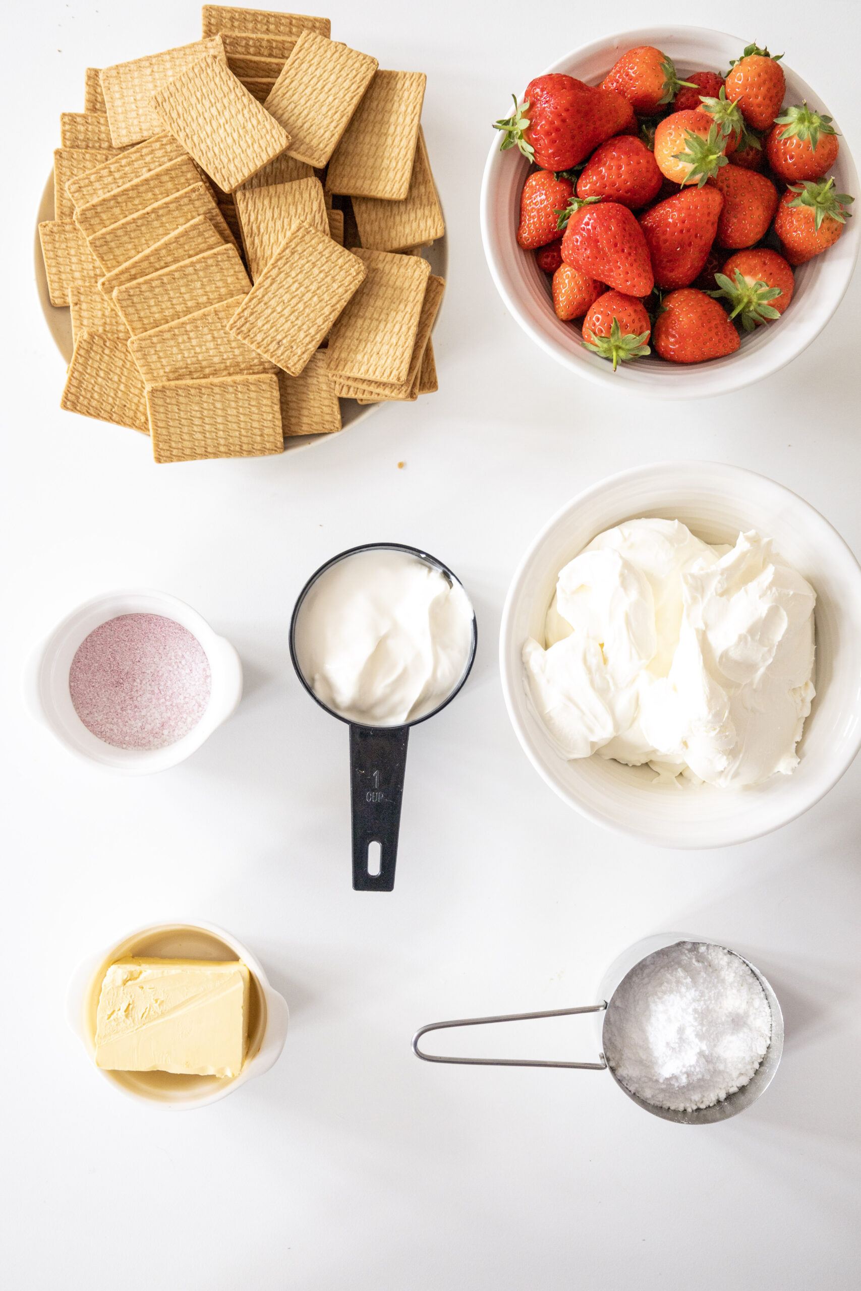 Strawberry cheesecake ingredients on a table.