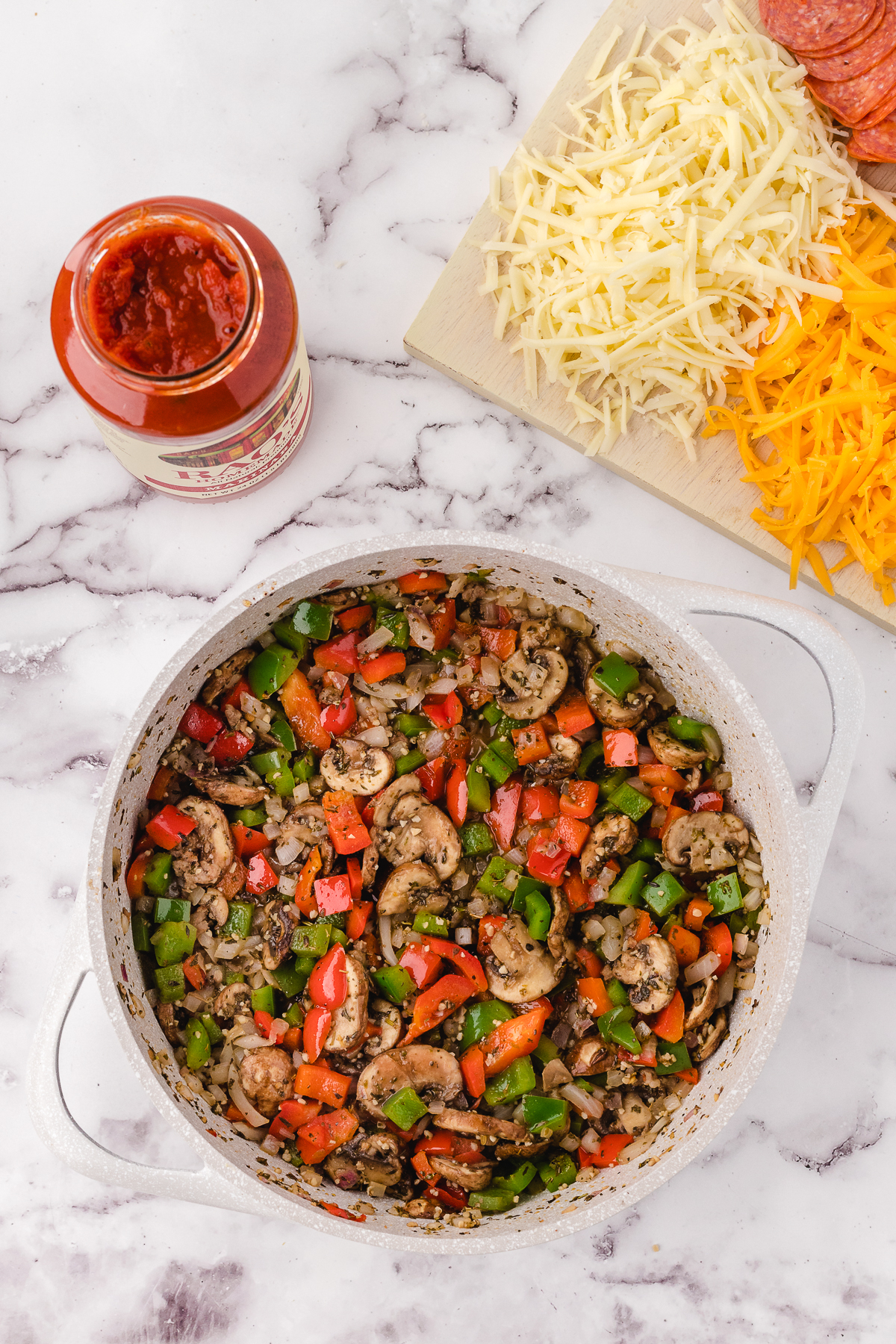Image of cooked sausage and veggies in a pan before assembling the casserole