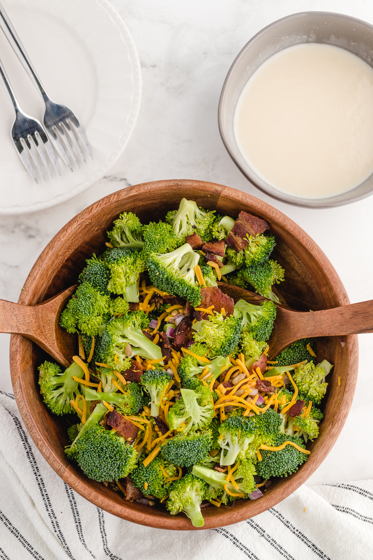 broccoli salad prepped with all the ingredients before tossed with the creamy mayo dressing