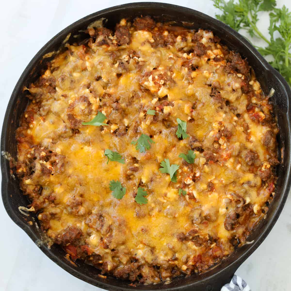 easy ground beef taco casserole topped with cheese and ready to serve