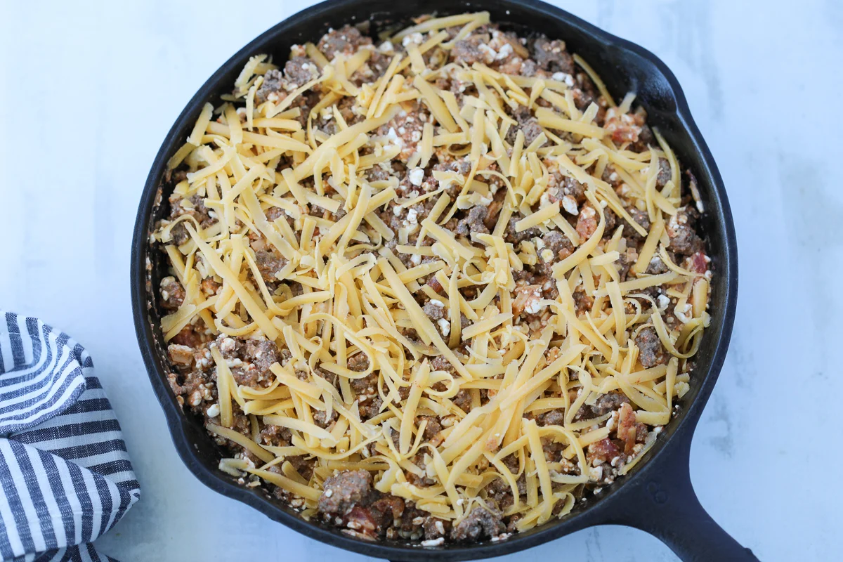 taco casserole in cast iron skillet before getting baked