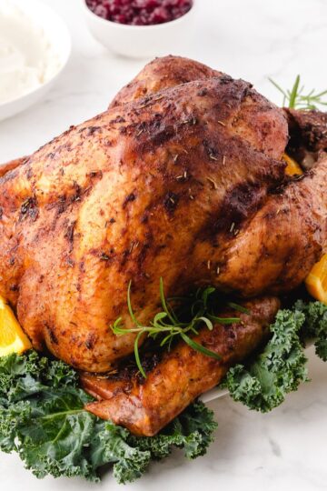 beautiful roasted turkey sitting on the dinner table