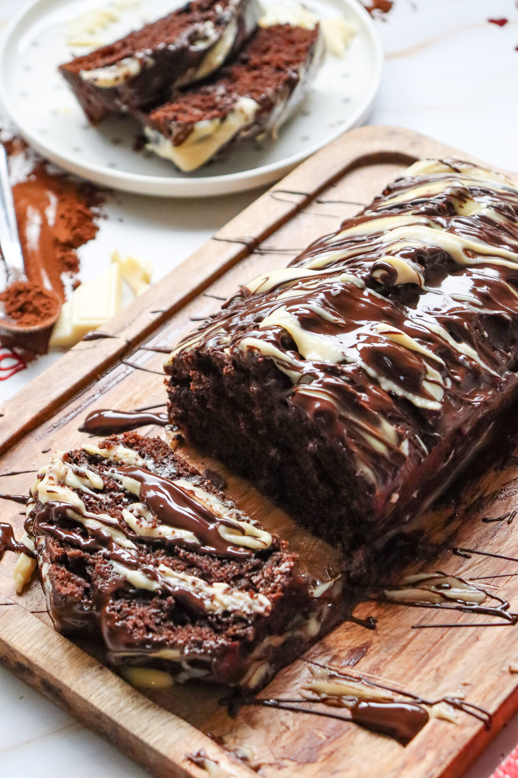 chocolate loaf cake on cutting board with slices