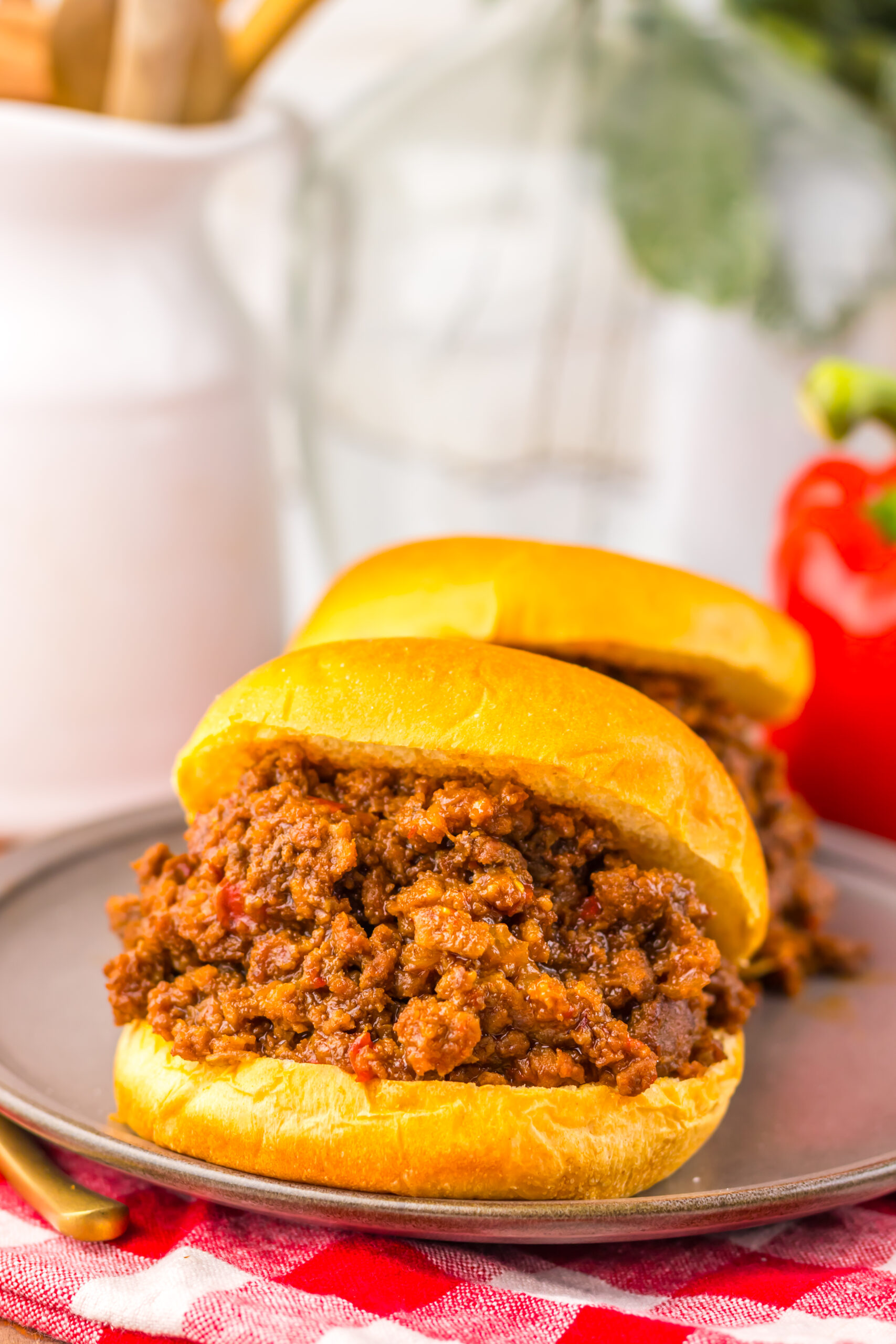 2 sloppy joe sandwiches being served a platter