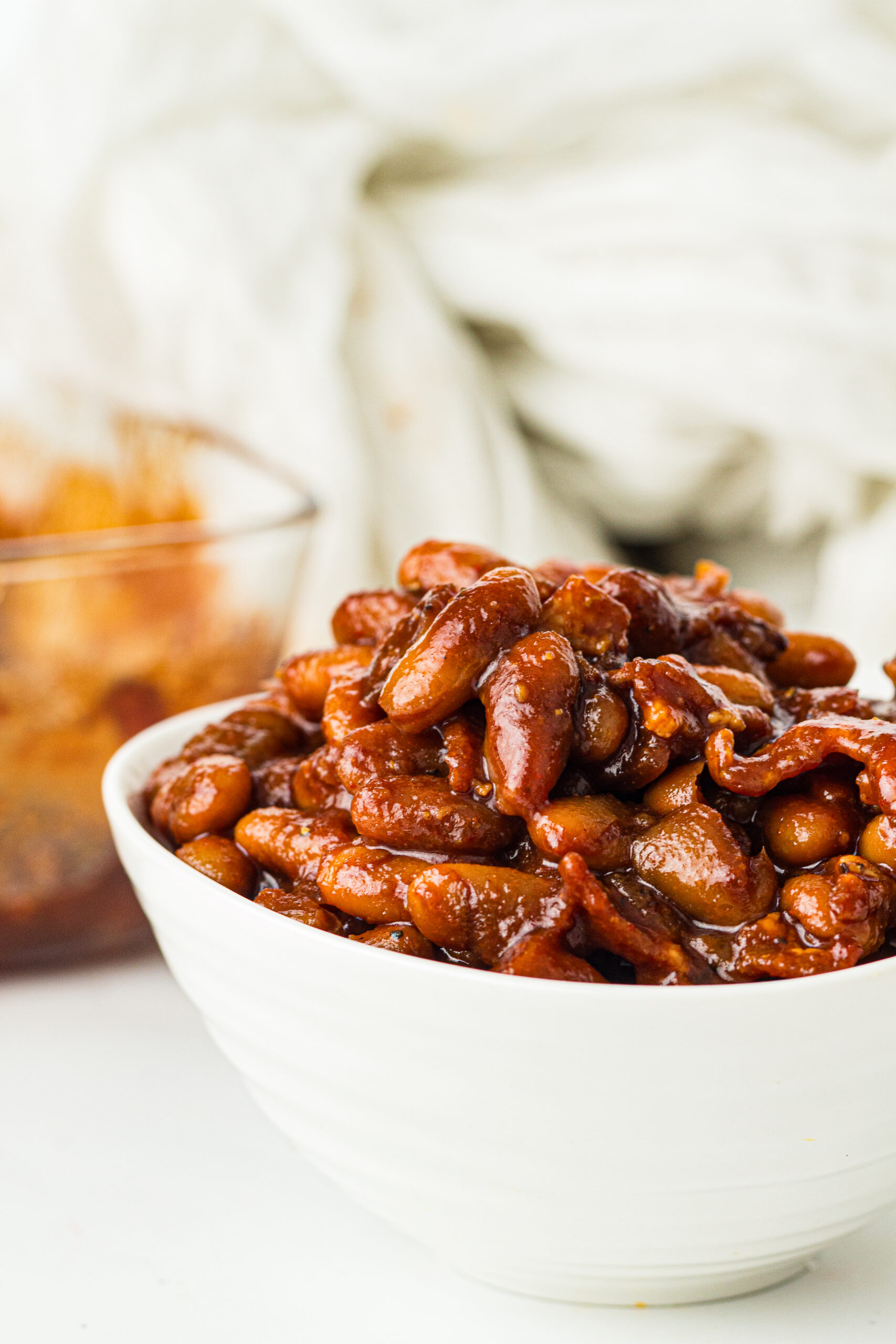 Southern Baked Beans sitting on a table in a white bowl.