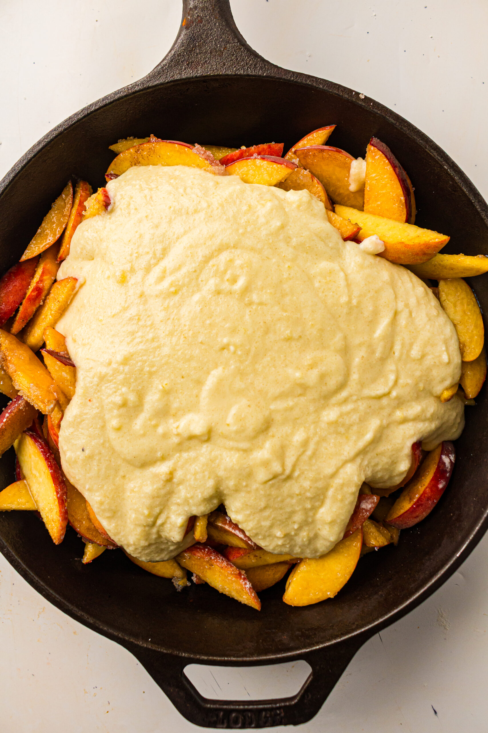 sliced peaches with batter on top