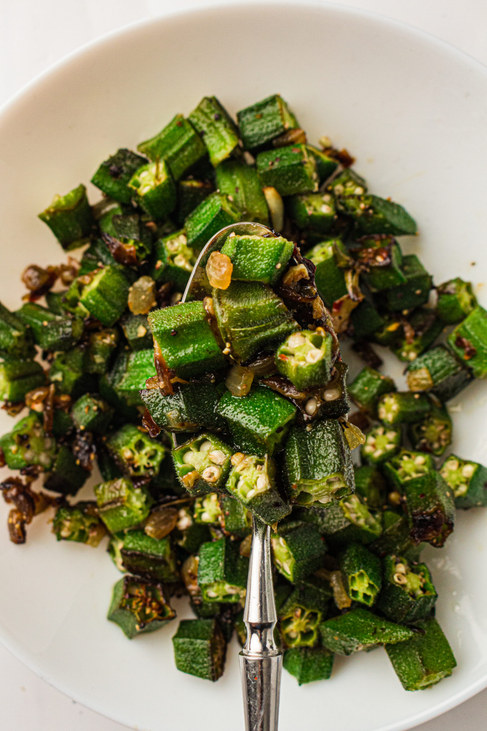 Pan fried okra with fork.