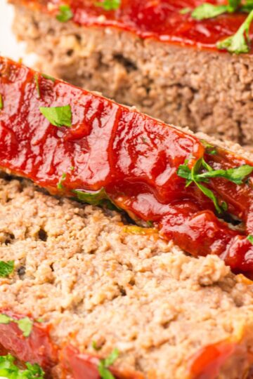 Sliced meatloaf served on a plate.