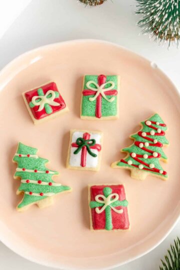 Old fashioned butter cookies for Christmas decorated with royal icing on a plate