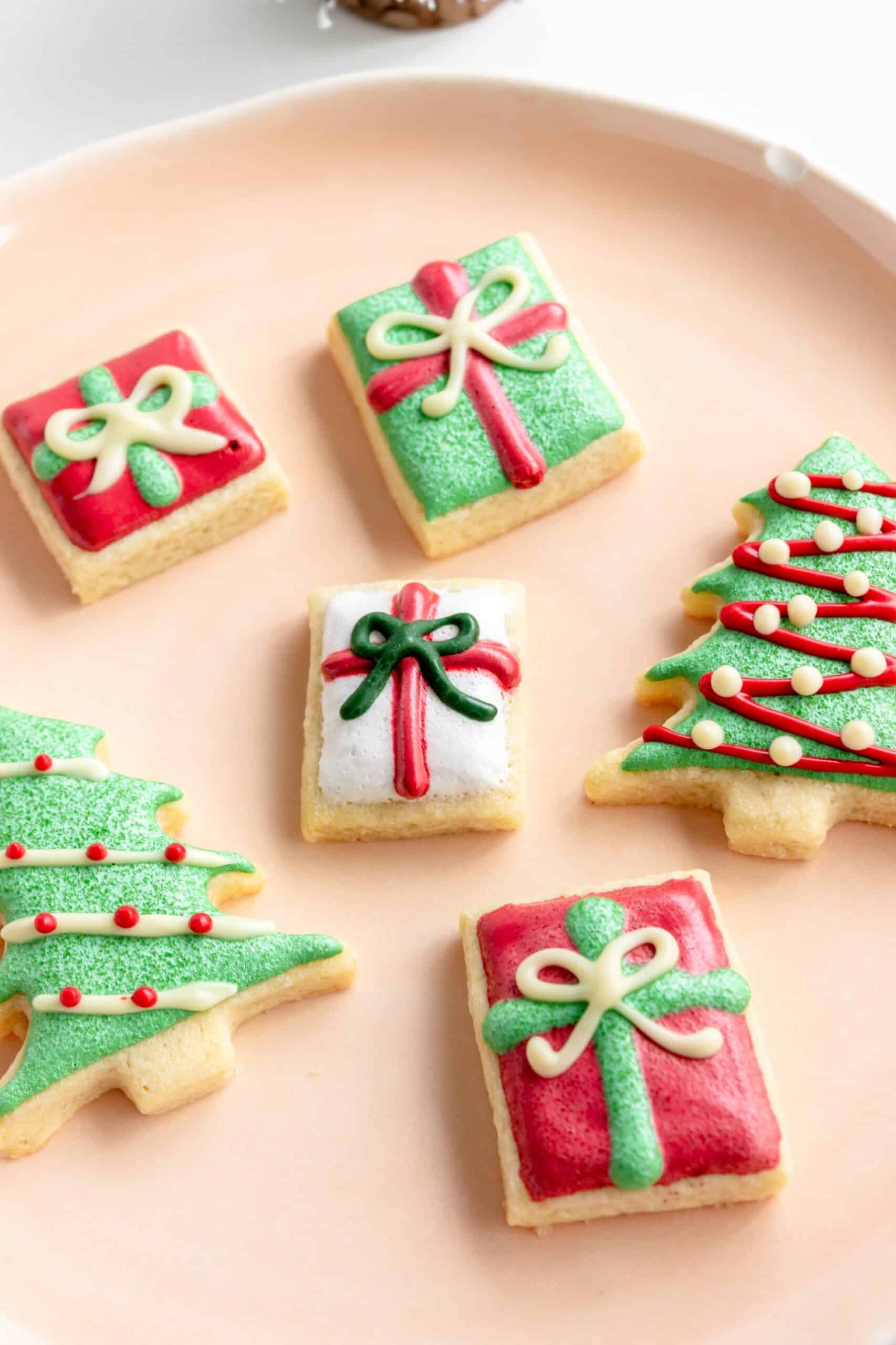 Christmas butter cookies decorated as trees and presents with royal icing