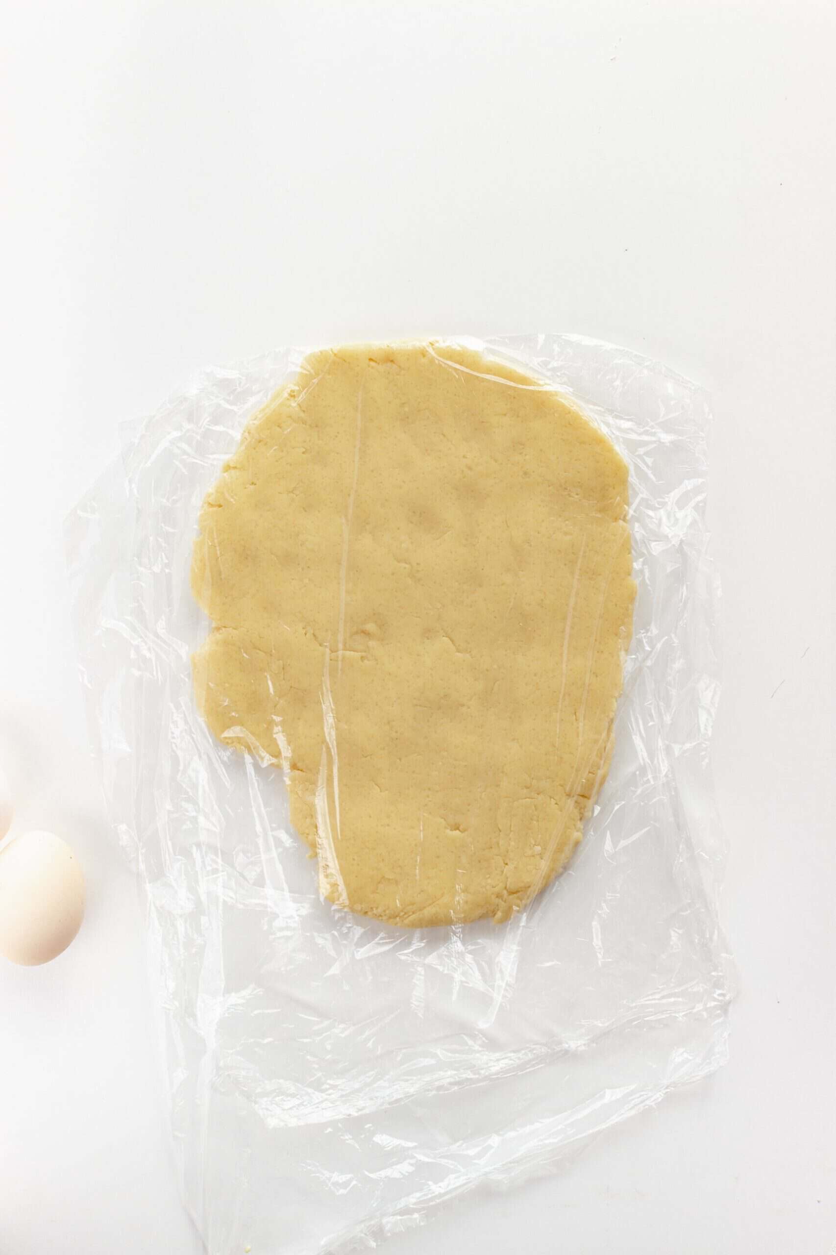 Butter cookie dough wrapped in plastic wrap to chill