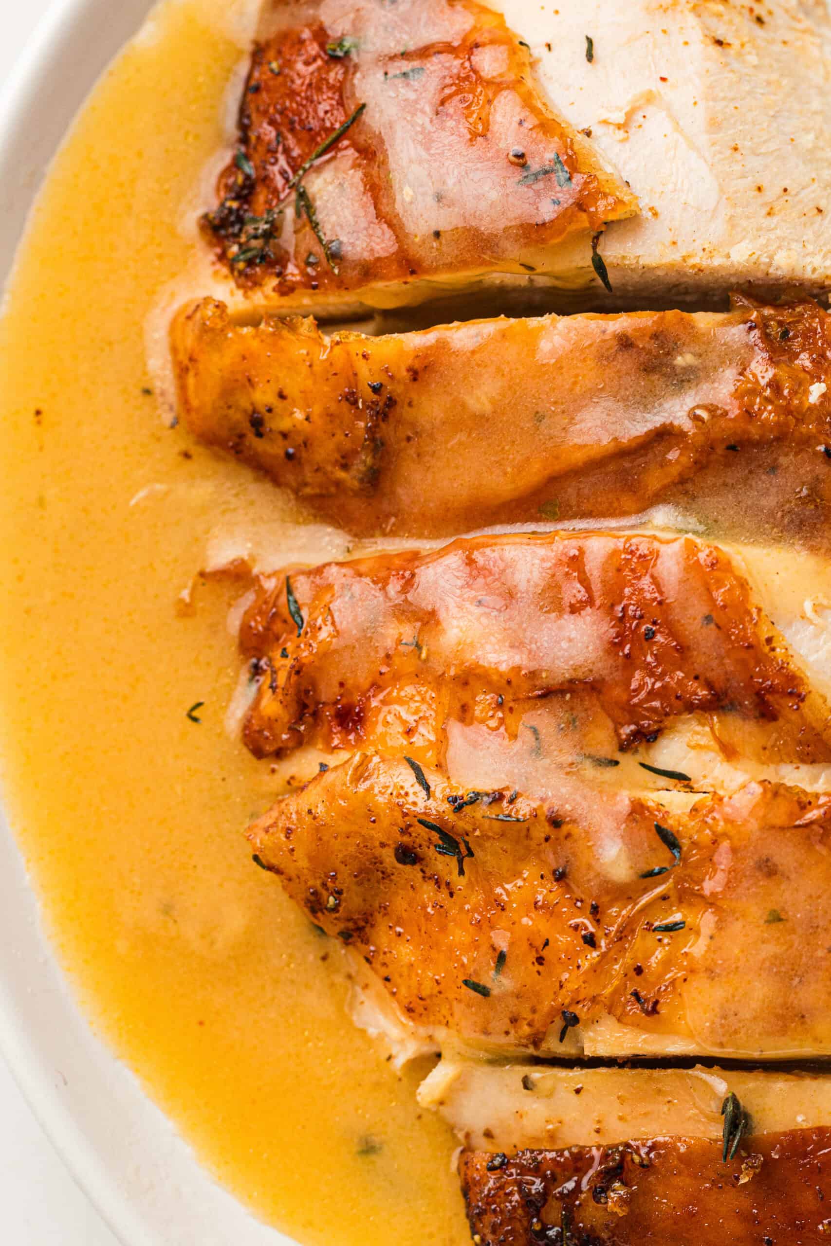 old fashioned turkey gravy with drippings poured over sliced turkey breast
