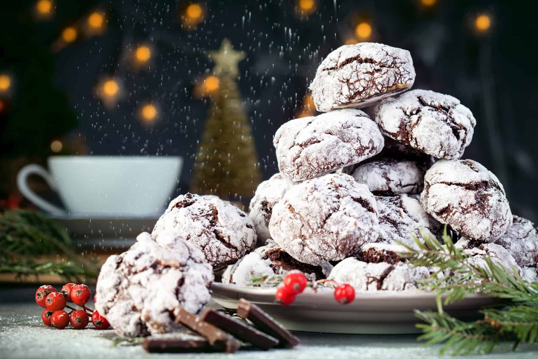 Old fashioned chocolate crinkle cookies piled on a plate for Christmas