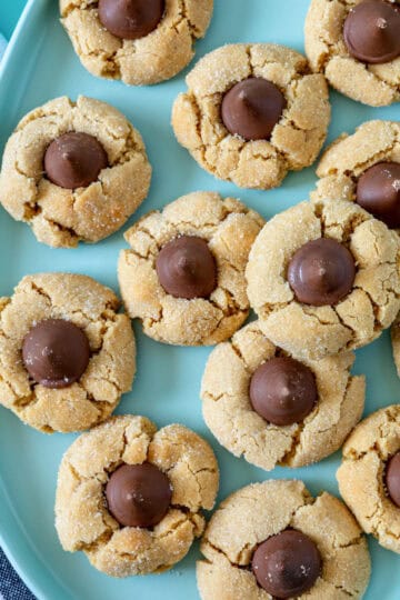 Peanut butter blossoms rolled in sugar and topped with Hershey's Kisses