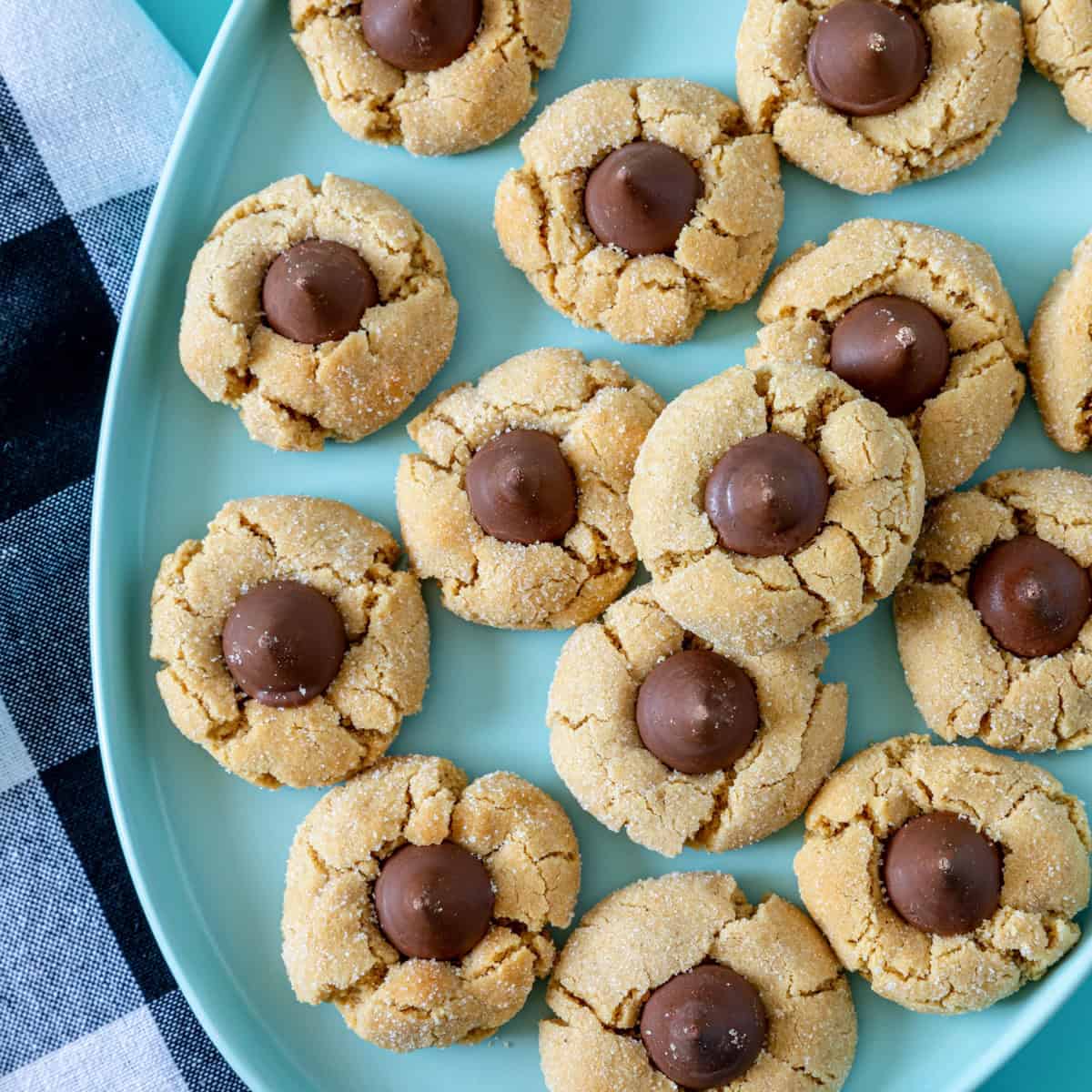 Peanut butter blossoms rolled in sugar and topped with Hershey's Kisses