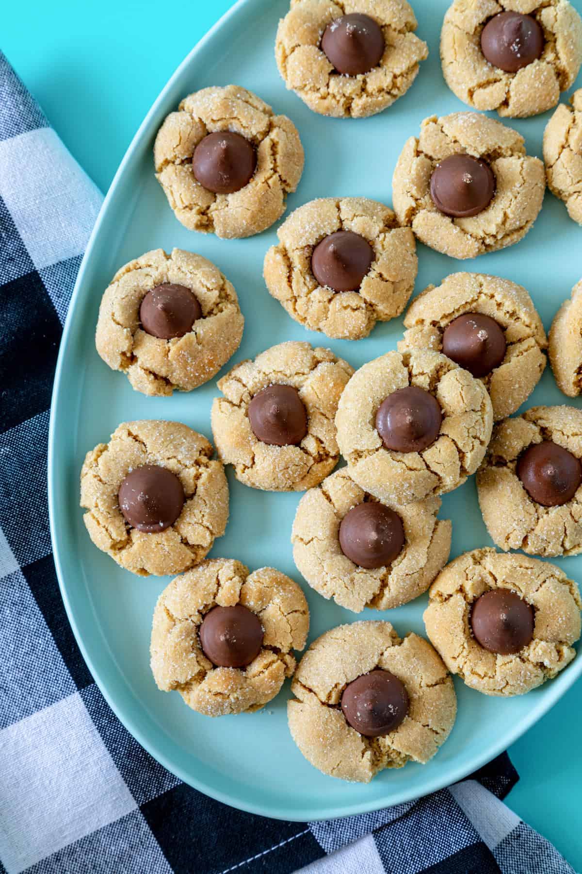 Classic peanut butter blossoms with chocolate kisses on a blue platter