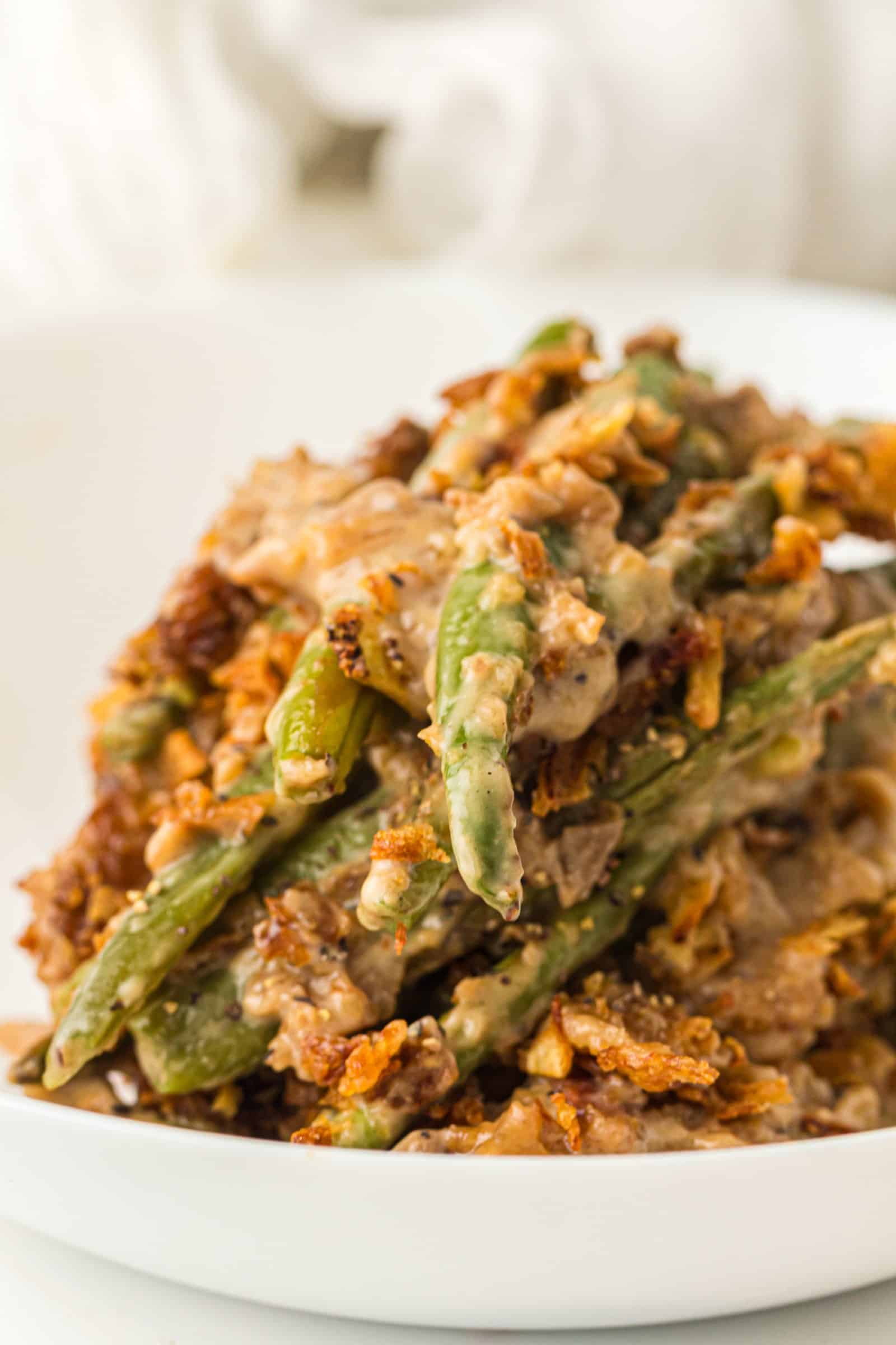 Bowl of green bean casserole with cream of mushroom soup.