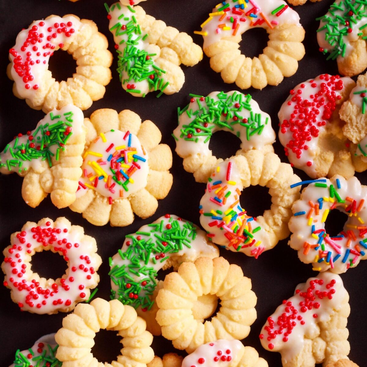 Easy spritz cookie wreaths and flowers with icing and sprinkles