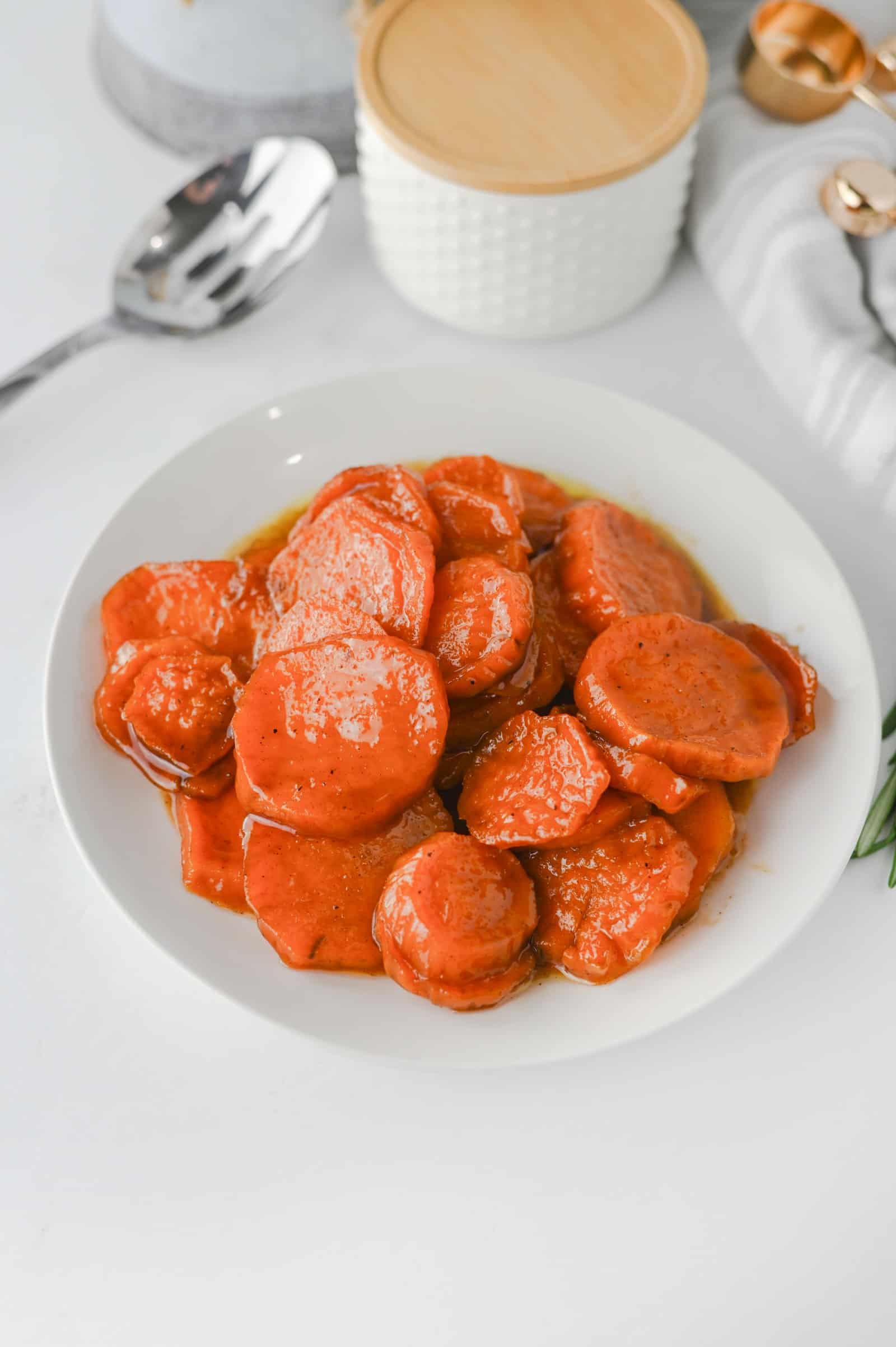Plate of old fashioned candied sweet potatoes in brown sugar glaze.