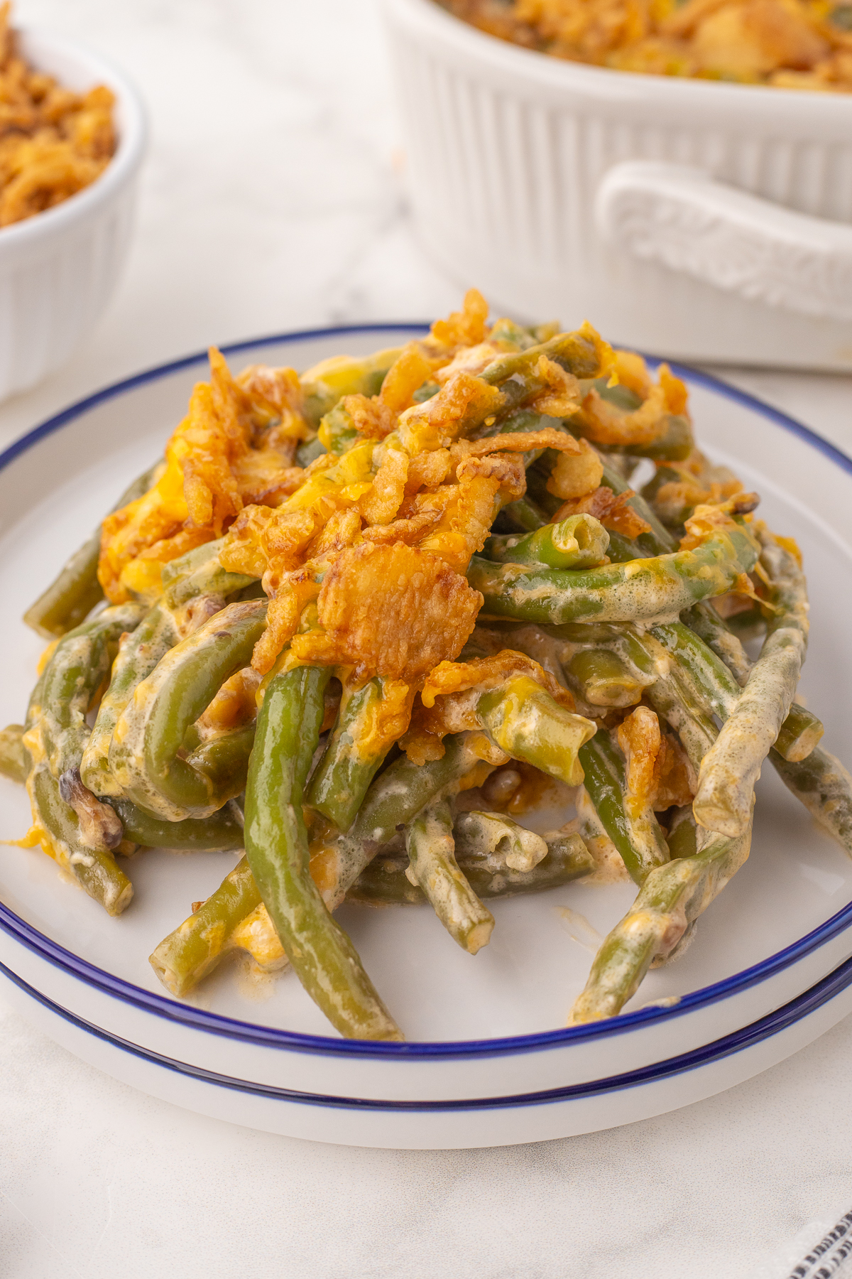 Old fashioned homemade green bean casserole with crispy fried onions on a plate