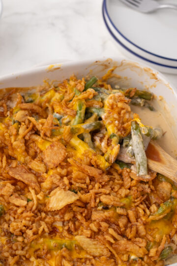 scooping green bean casserole onto a spoon