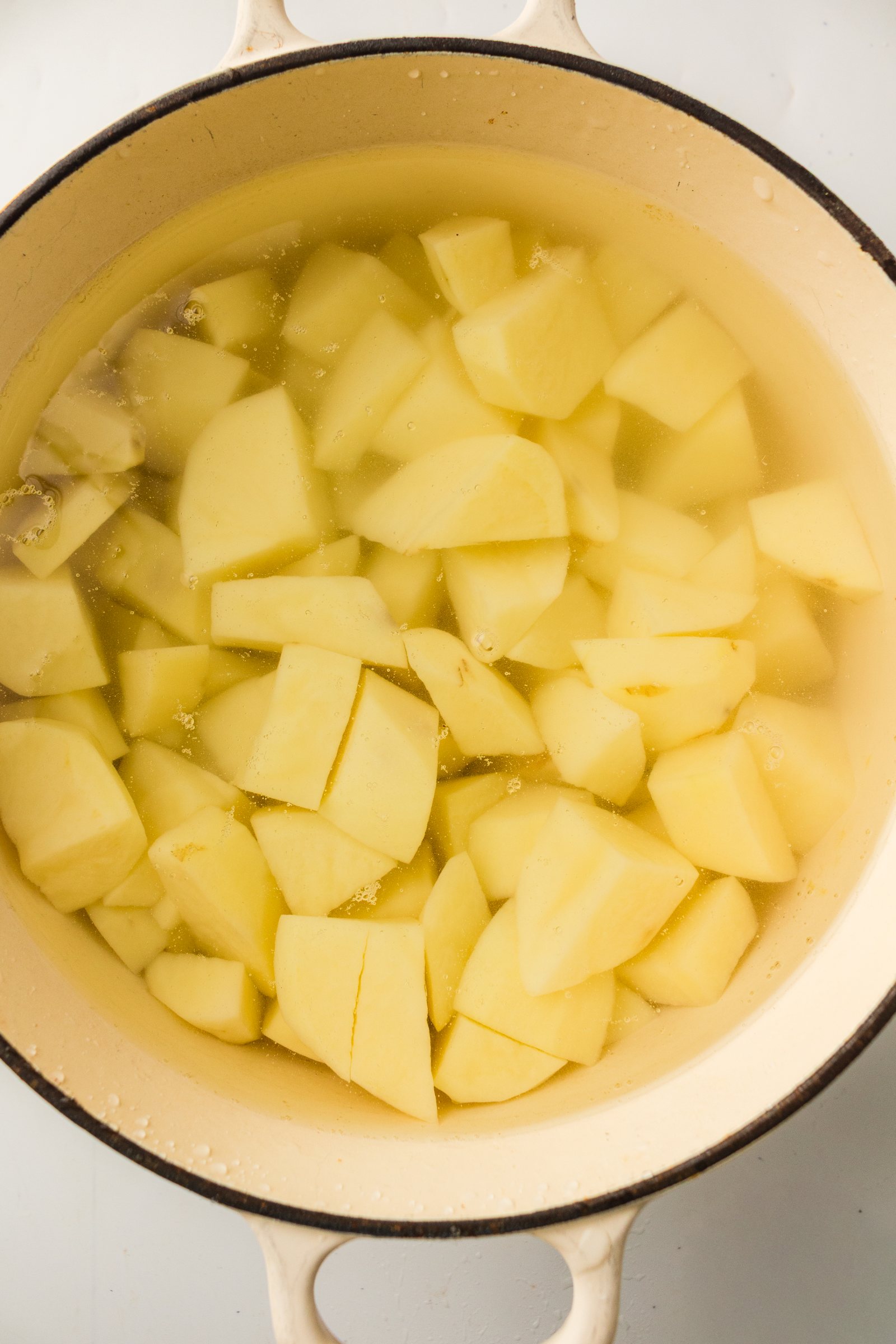 Peeled, cubed potatoes in a pot for old fashioned mashed potatoes.