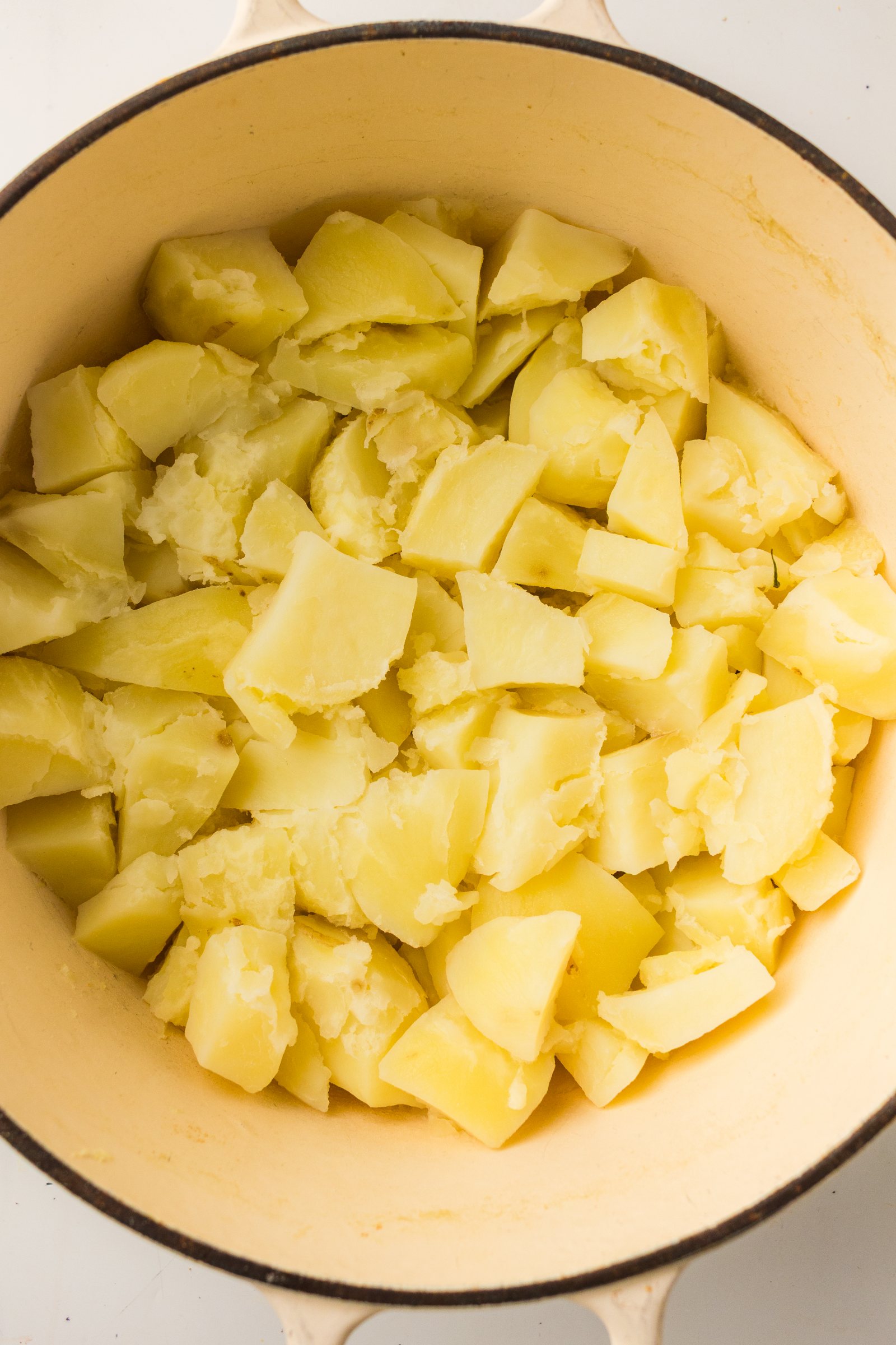Drained boiled potatoes back in the hot pot.