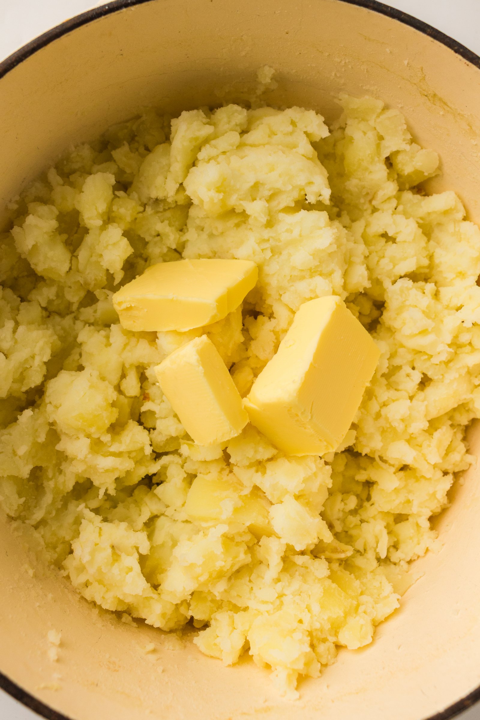 Butter added to hot mashed potatoes.