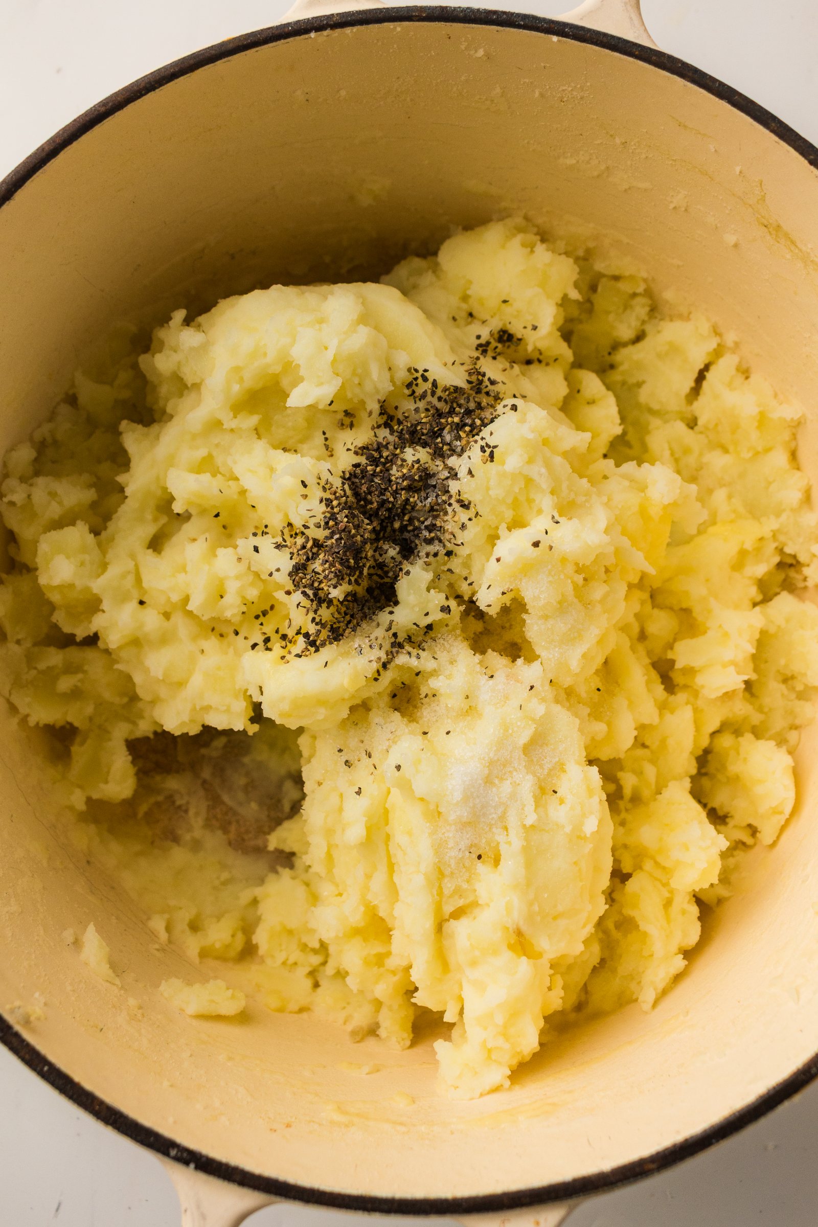Salt and pepper on old fashioned mashed potatoes.