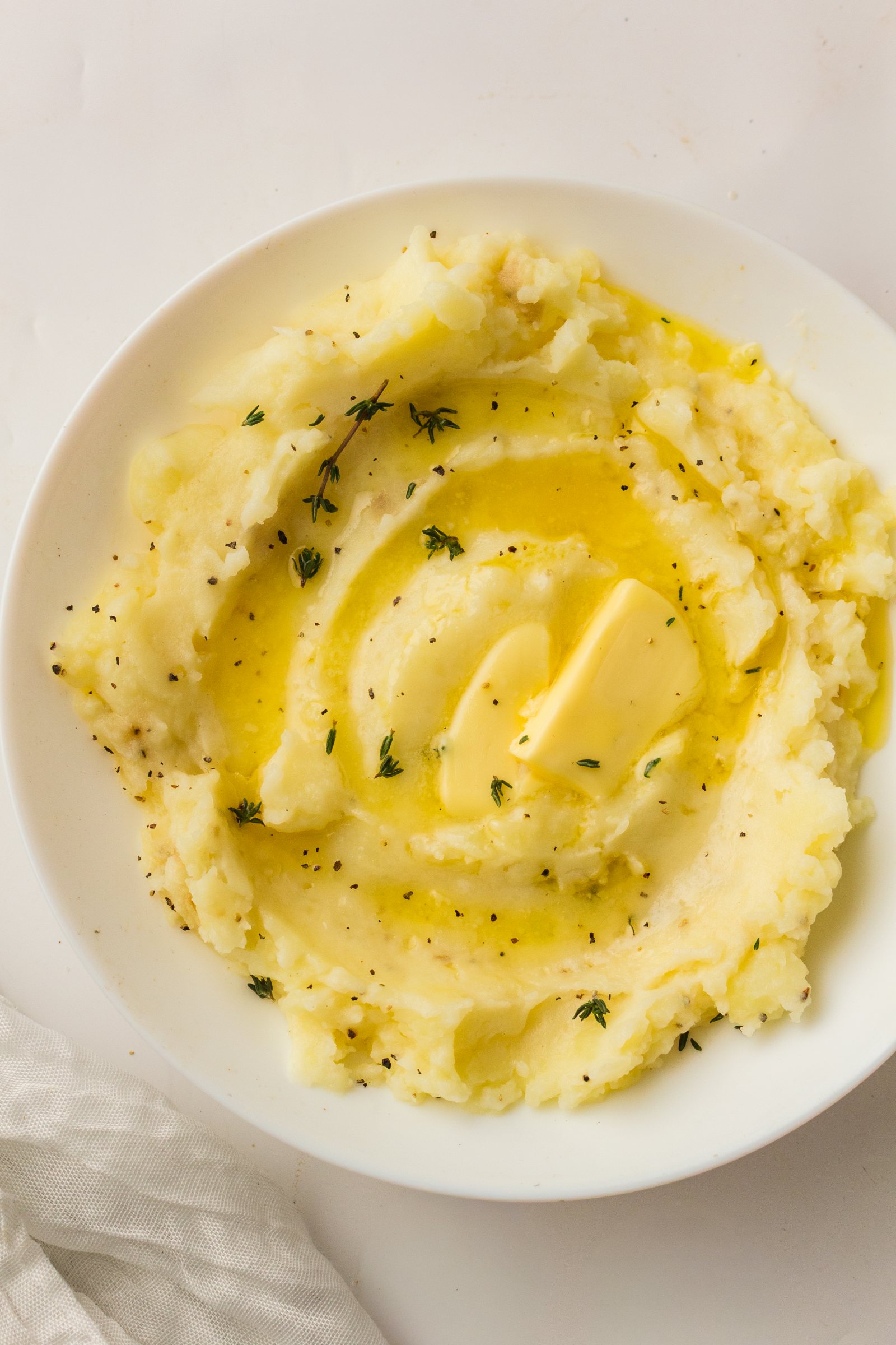 Bowl of old fashioned mashed potatoes with butter, from above.