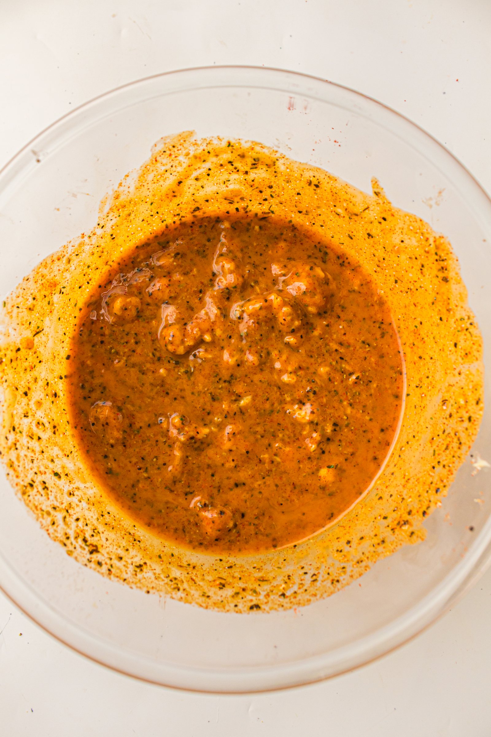 Seasoned butter for roast turkey mixed in a glass bowl.