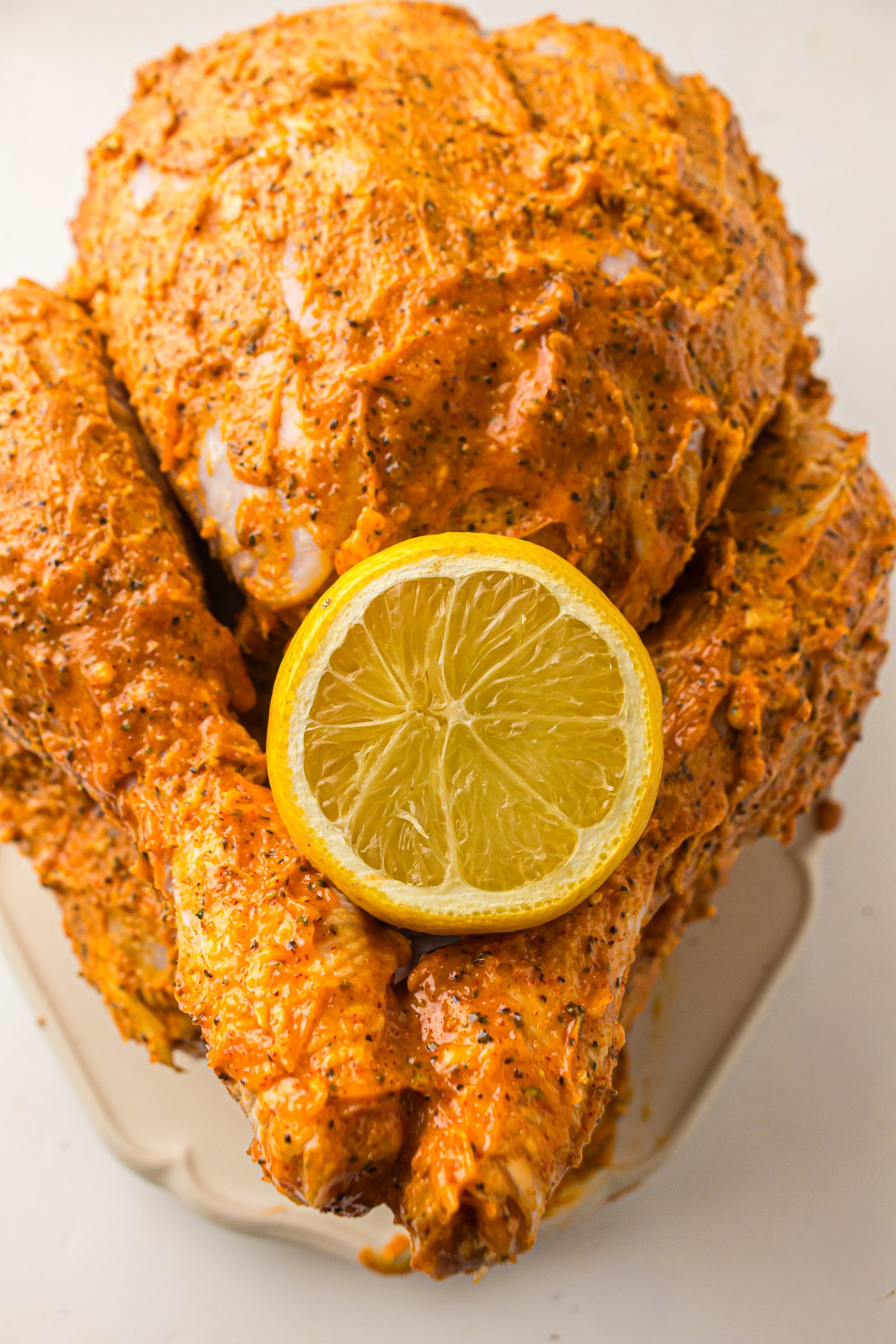 Buttered turkey with a lemon tucked into the cavity.