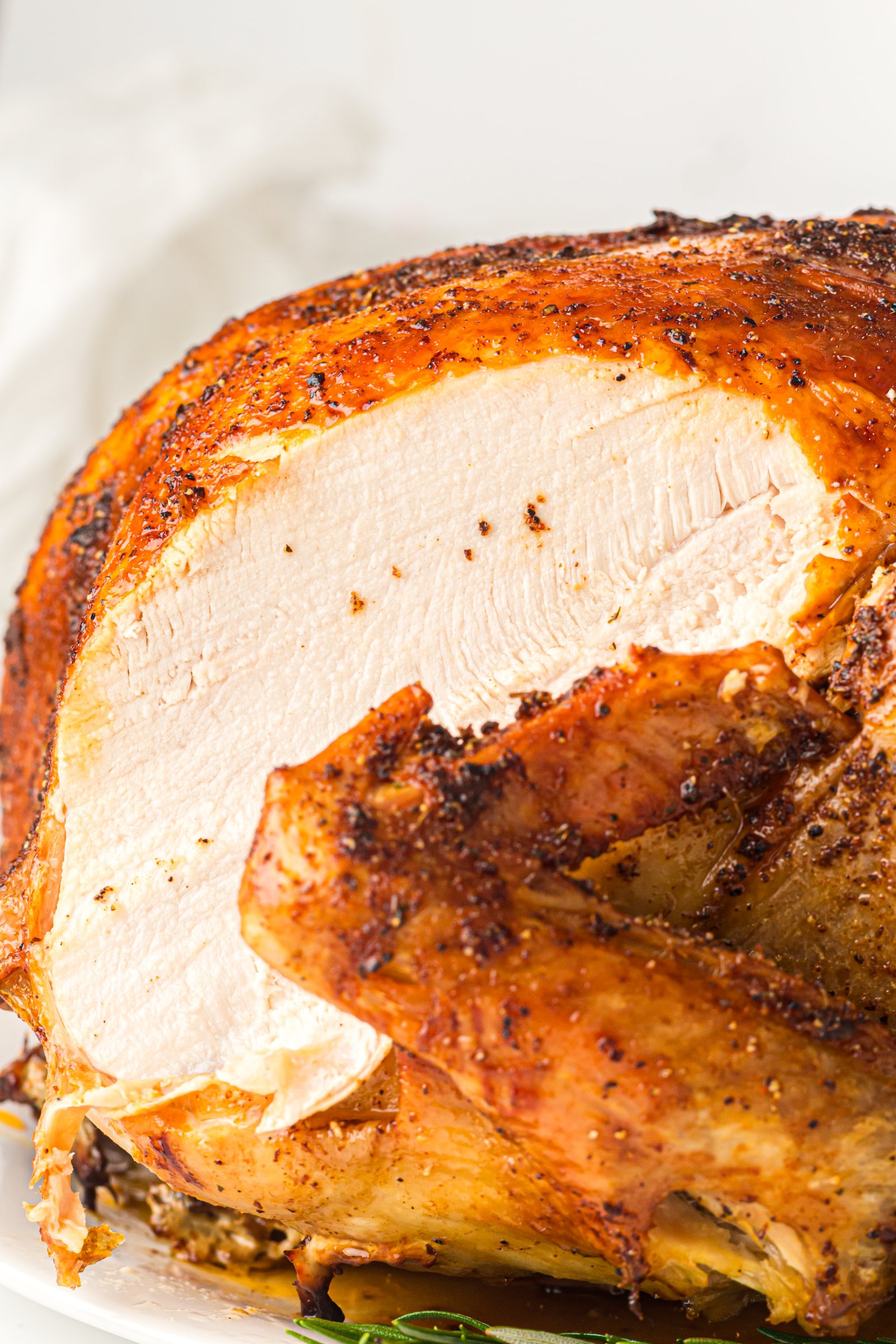 Carved roast turkey breast showing juicy white meat and crisp skin.